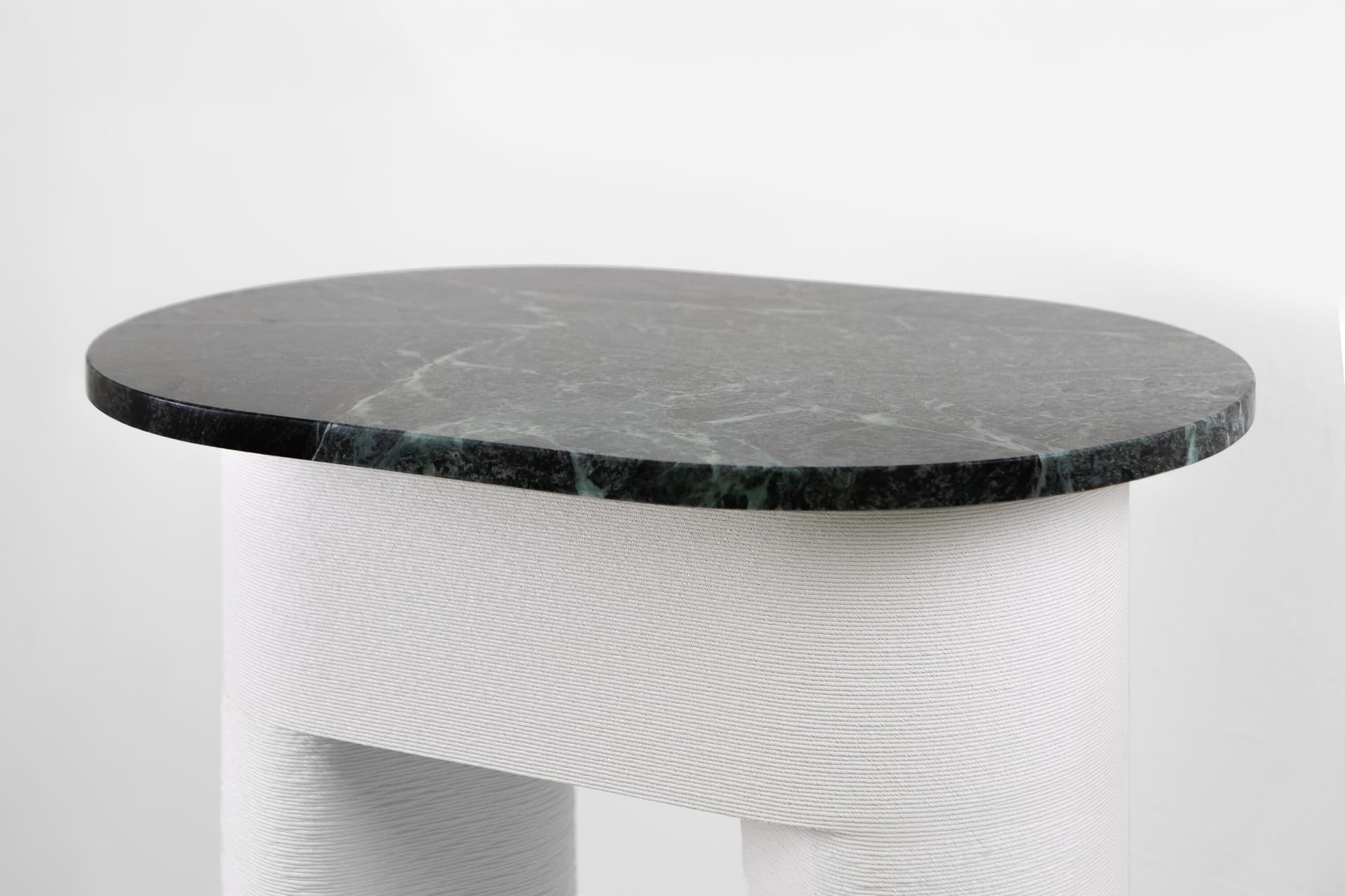 Designtech
OTEL
Oval side table in engineered polymer and Verde Alpi marble